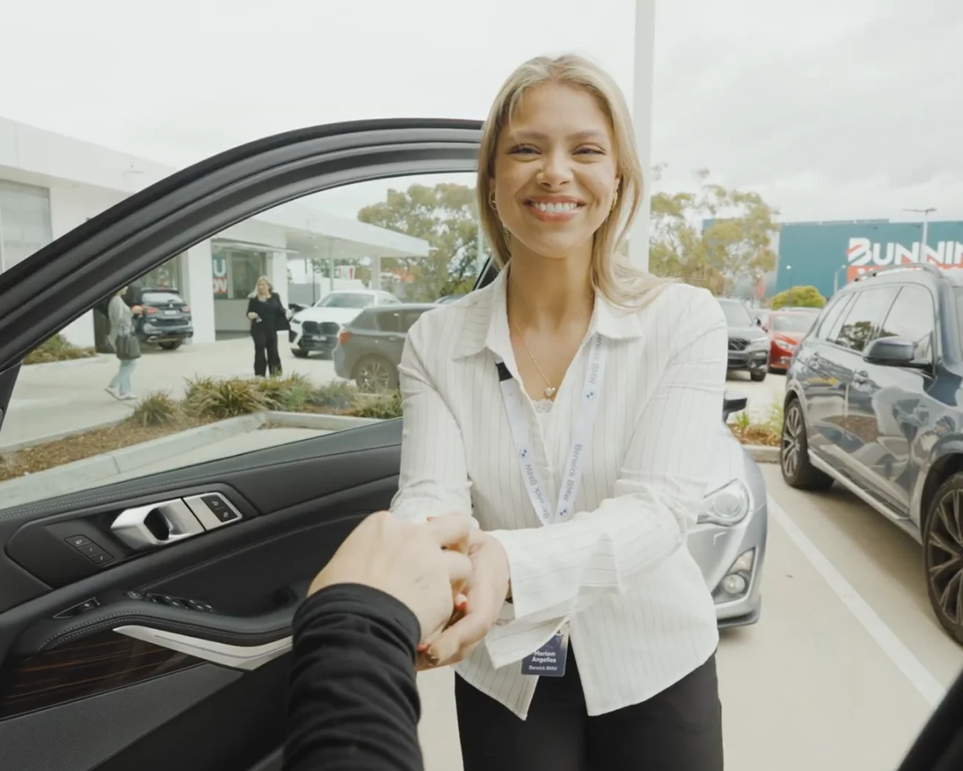 JMG Used Cars team member helping a customer inspect a used car in Victoria